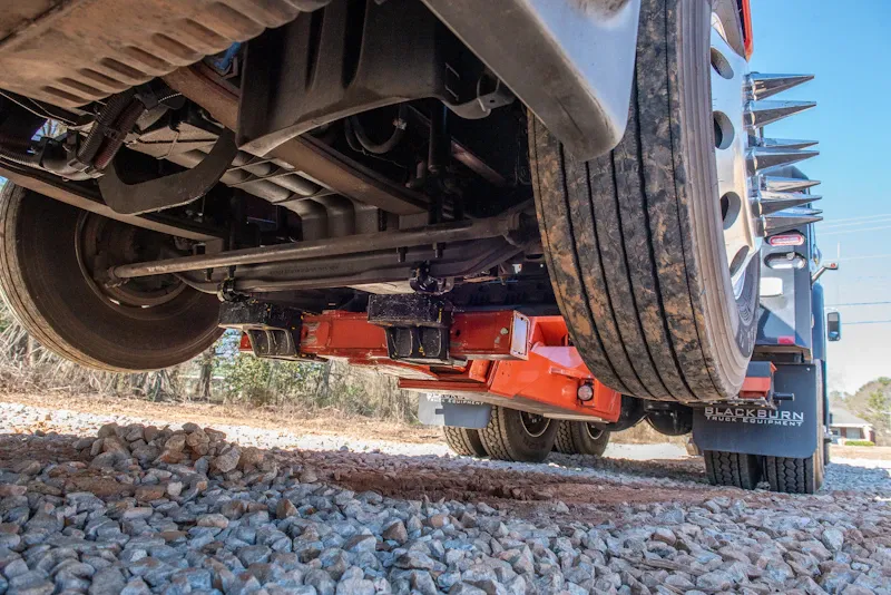 Roadside heavy-duty towing service lifting a disabled commercial truck by the front axle for safe recovery and transport.