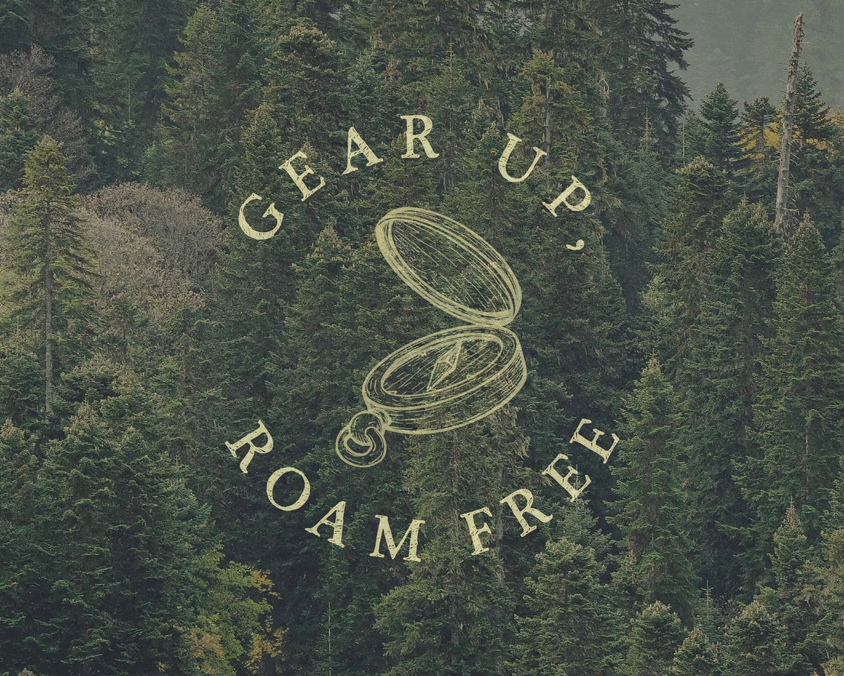 Dense green forest with illustrated open compass and text reading 'Gear Up, Roam Free' in a circular layout.