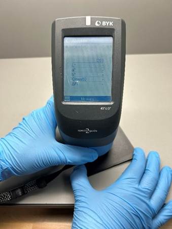 A person wearing blue gloves holding a deviceAI-generated content may be incorrect.