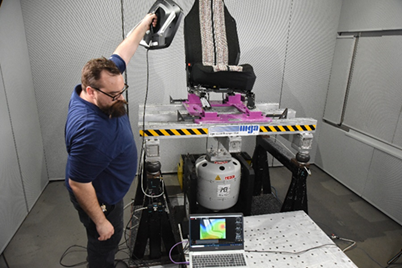 A person holding a black object in front of a computerAI-generated content may be incorrect.