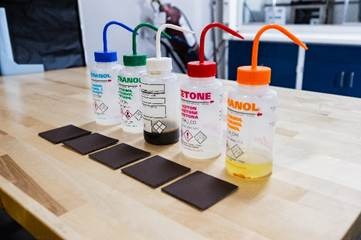 A row of bottles with straws and a few square tilesAI-generated content may be incorrect.