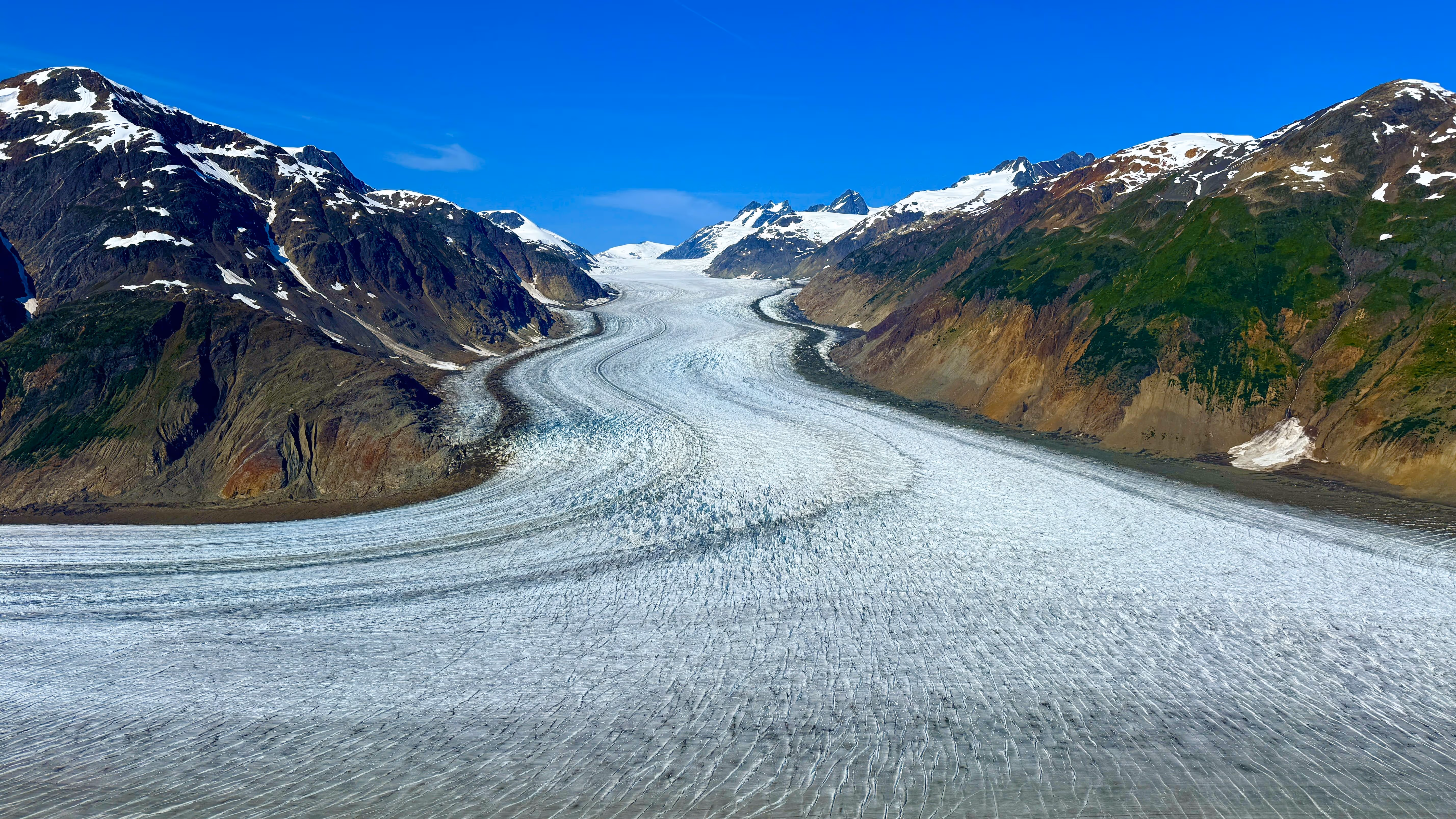 View of Salmon Glacier's vast ice expanse and rugged landscape. Highlights the ultimate BC road trip itinerary. Blog Image