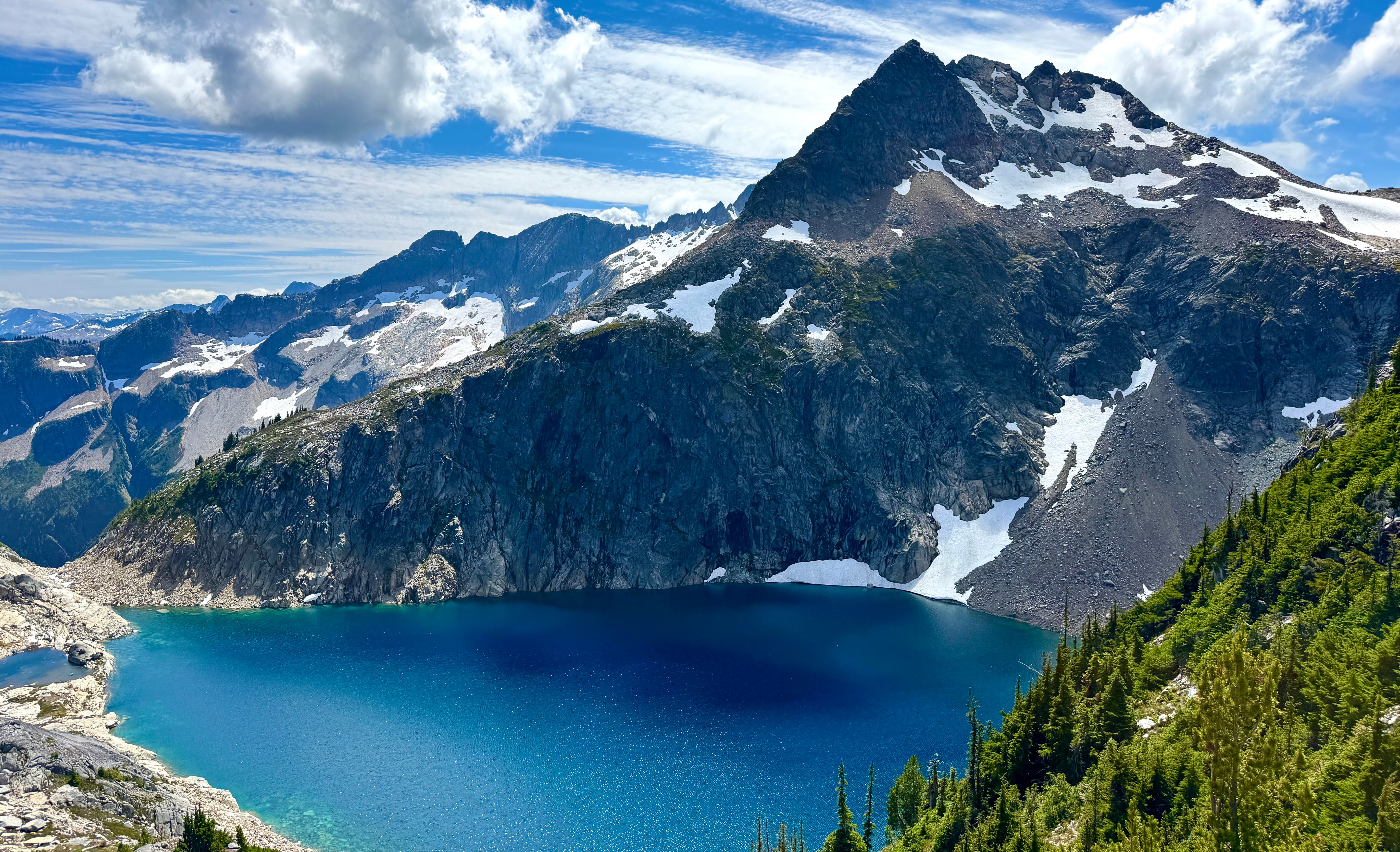Crystal-clear turquoise Upper Hanging Lake from Mount Lindeman trail, BC, nestled in a dramatic hanging valley with steep rock walls and alpine scenery