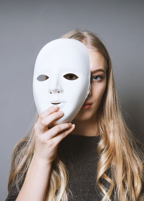 woman holding face mask