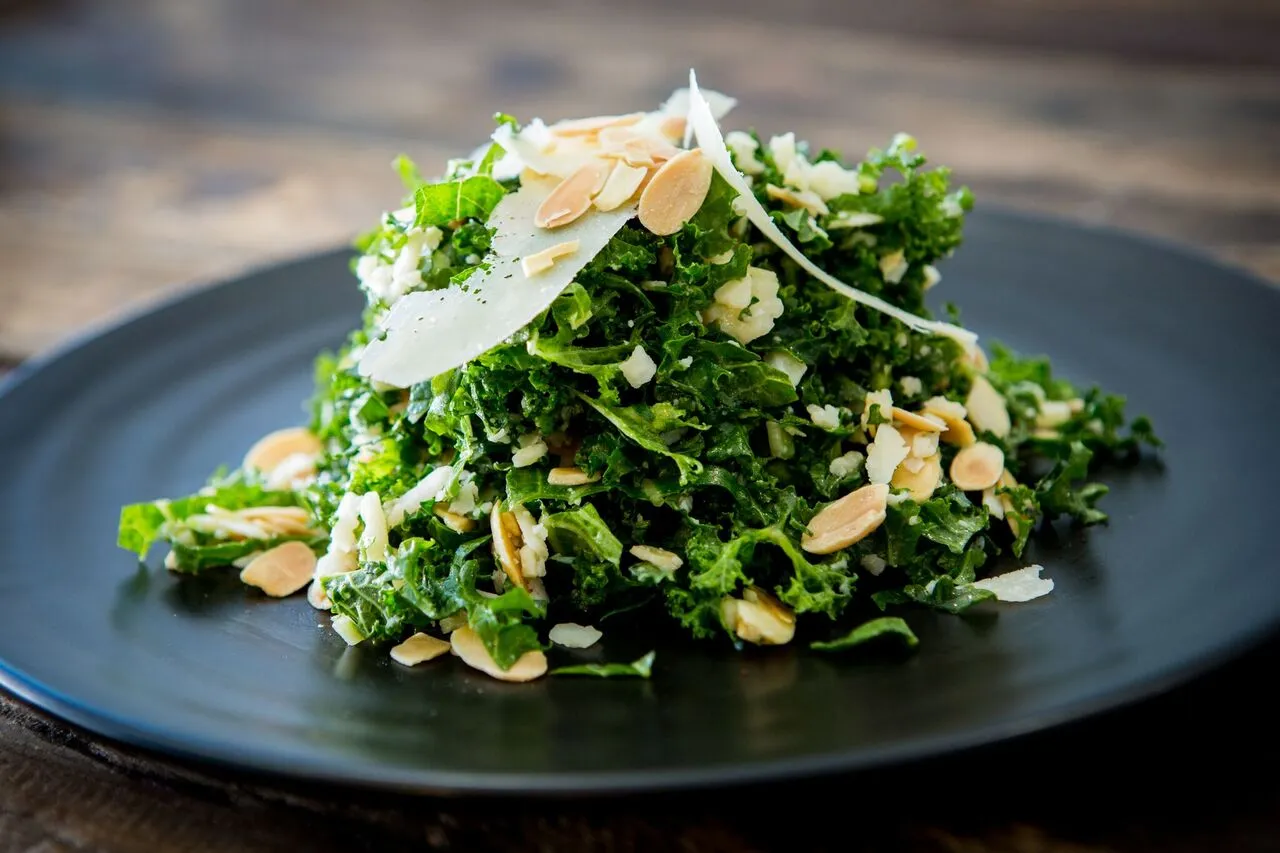 Kale salad with seasonal toppings, prepared by Bartleby & Sage for a corporate catering event