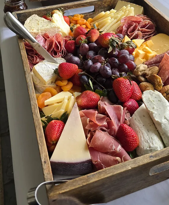 A drop-of box of cheese, fruit, meat and crackers prepared by Bartleby & Sage.