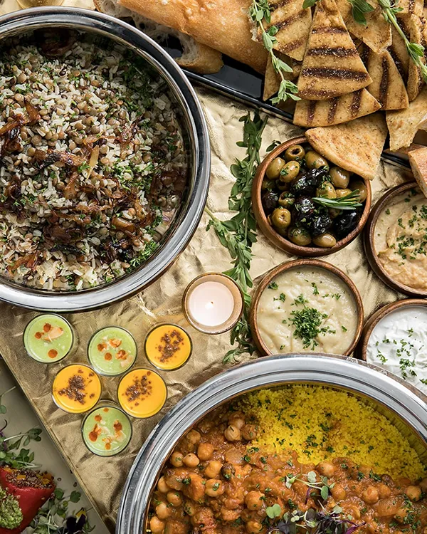 Middle Eastern mezze dinner station at a Bartleby & Sage-catered event, featuring hummus, flatbreads, and seasonal dishes