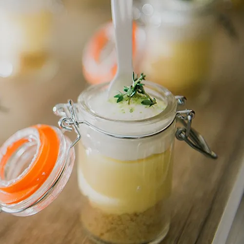 Individual lemon meringue pie served in mason jars.