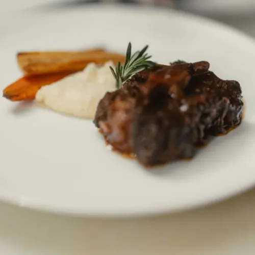 A plate of deliciously cooked and styled food on a white plate.