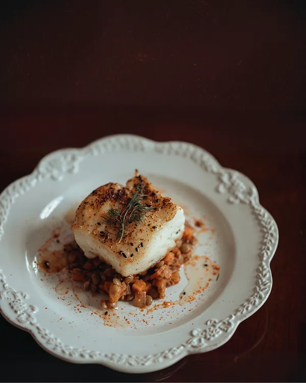 Pan-seared sea bass dish prepared by Bartleby & Sage's culinary team for an upscale catering event