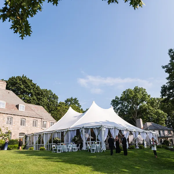 A lakeside, outdoor wedding with a huge tent created by Bartleby & Sage.