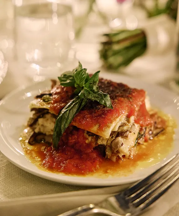 Plated lasagne at a sit-down wedding.