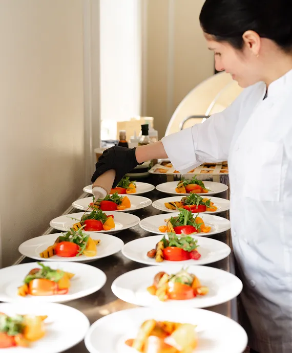 Preparing burrata plates for a private event planned and catered by Bartleby & Sage. 