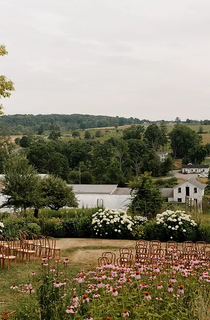 A wedding planned by Bartleby & Sage set up in a field full of flowers at Glynwood.