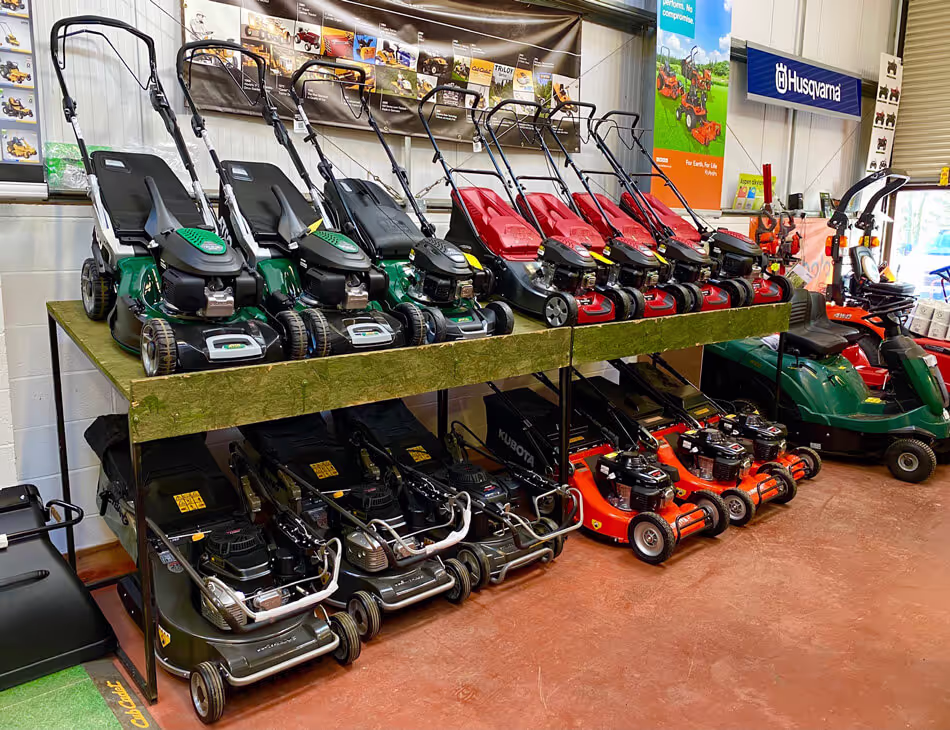 Lawn mowers stacked on wall of showroom