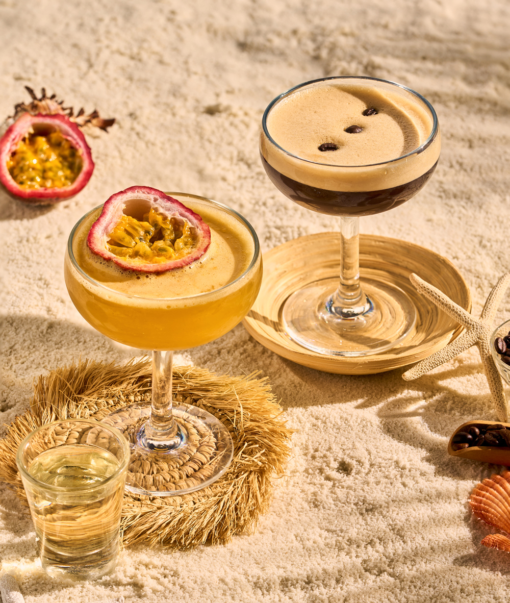 Girls holding cocktails in the swimming pool