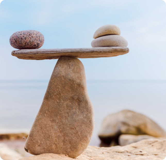 Rocks balancing on top of each other at a beach, a symbol of mindfulness and peace