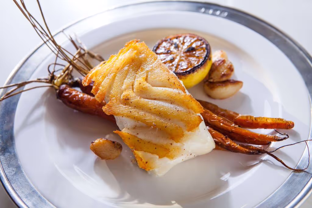 A plate of food with fish and vegetables.