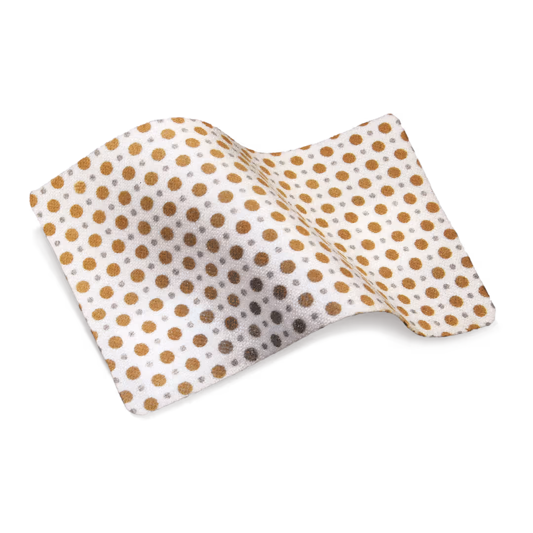 JumpStart antimicrobial wound dressing with a flexible white base covered in evenly spaced brown circular dots.
