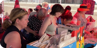 People browsing stalls at a busy market.