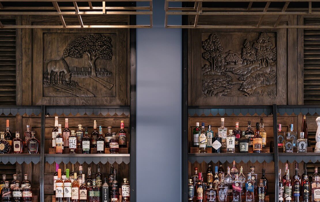 A wall of liquor bottles in a bar.