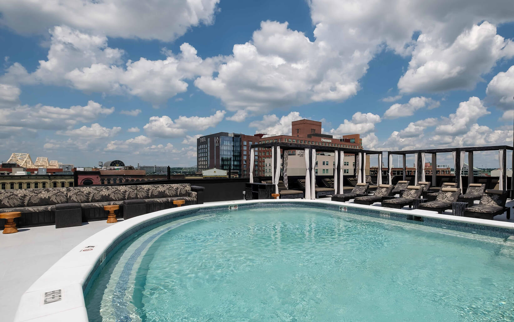 A large swimming pool on top of a building.