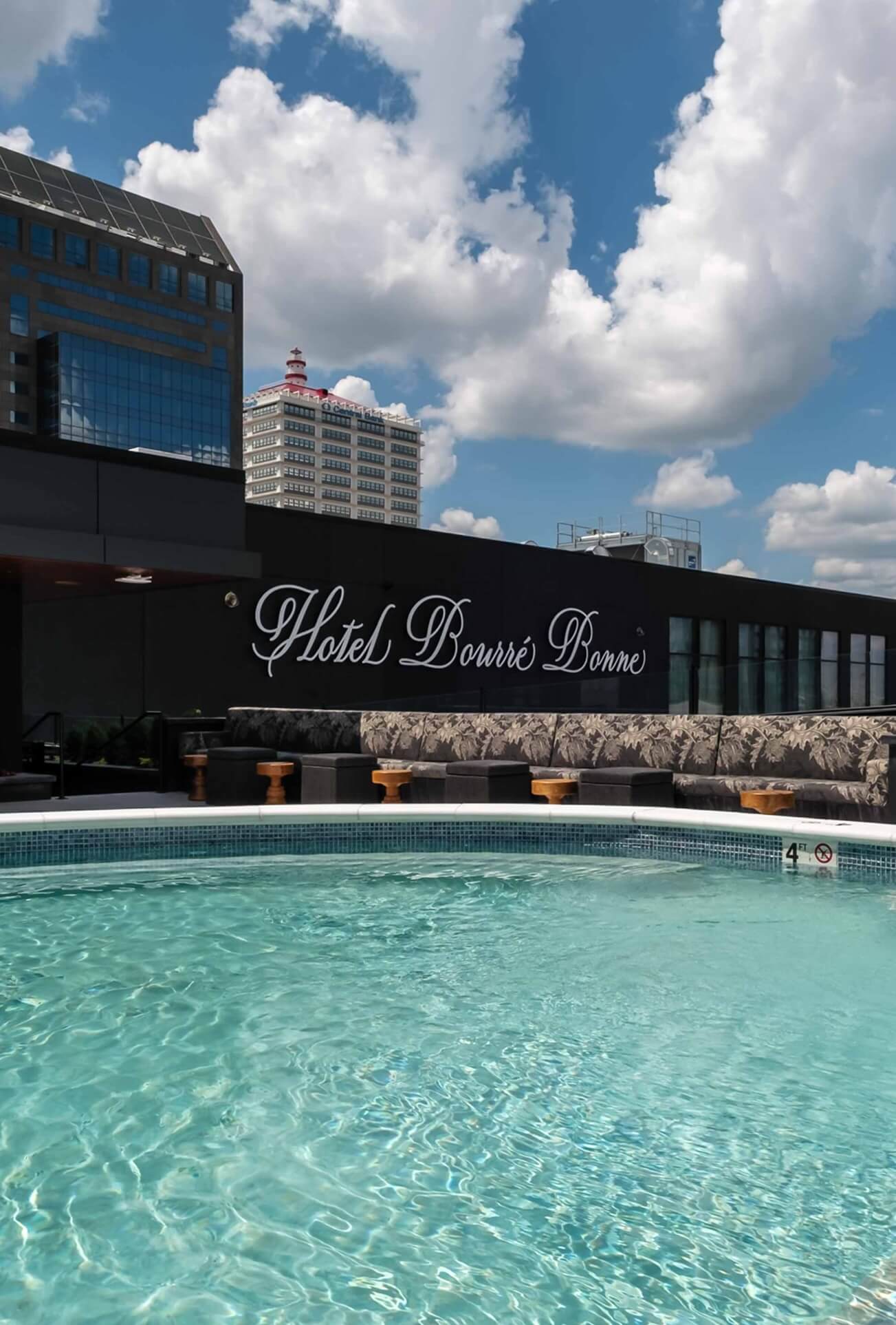 A large swimming pool in front of a building.
