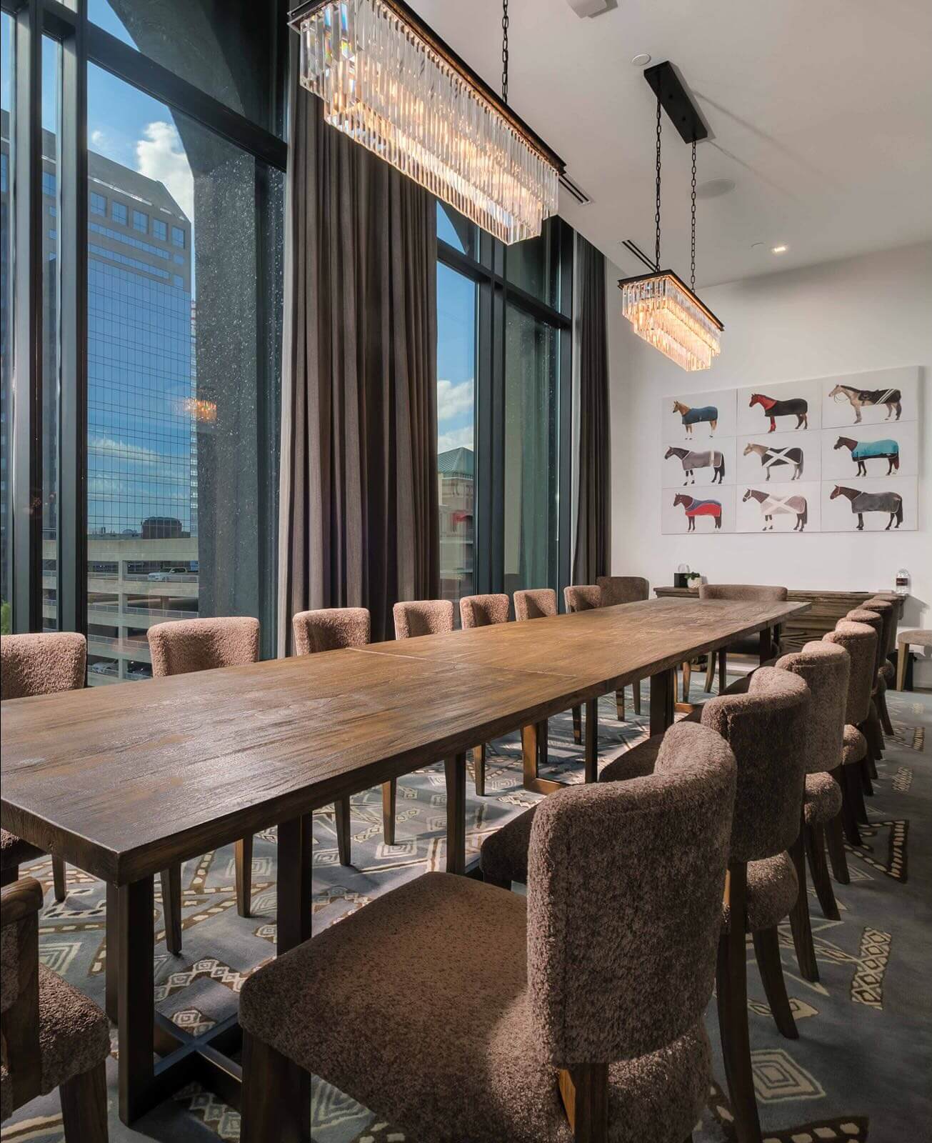 A conference room with a long table and chairs.