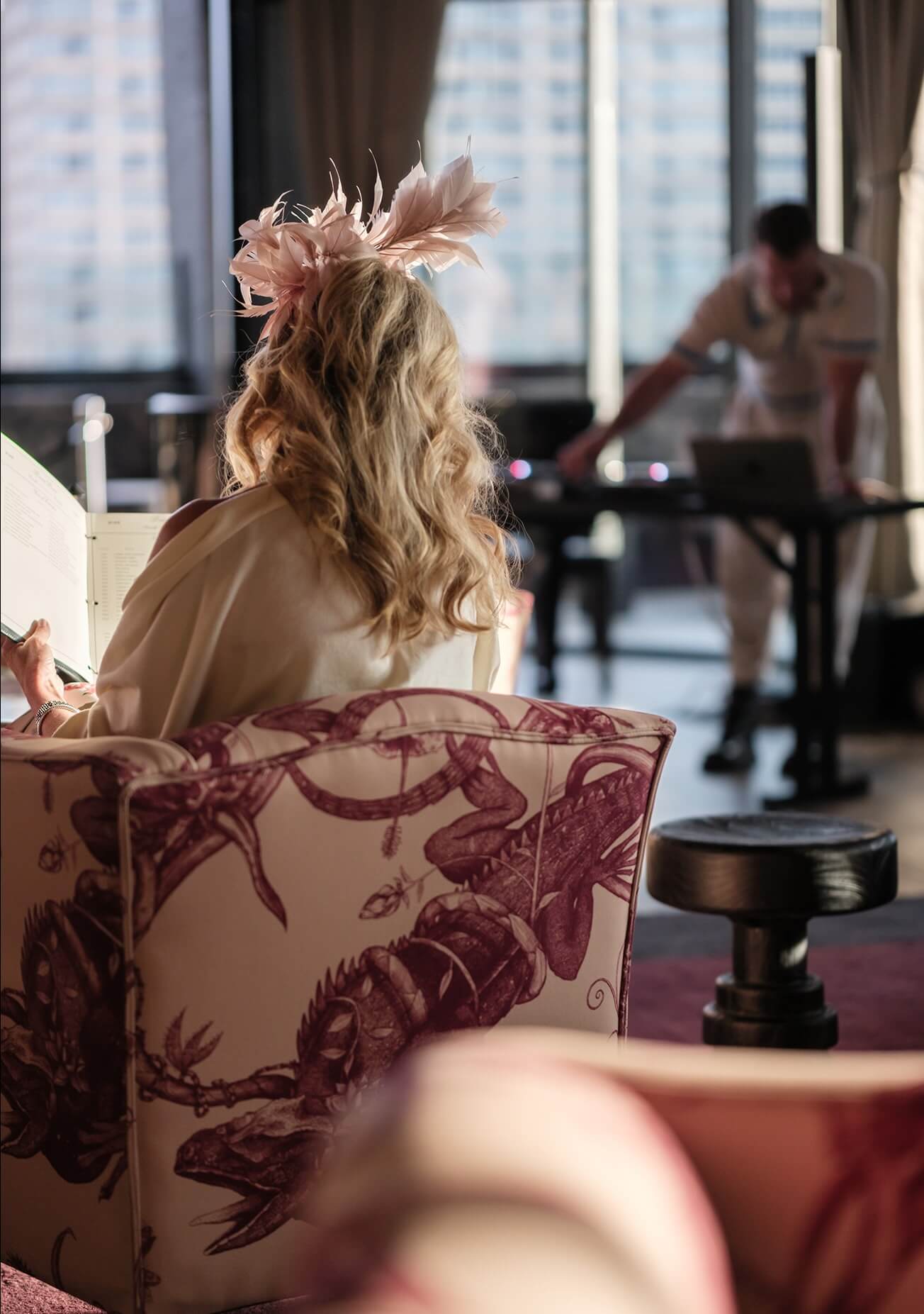 A woman sitting in a chair with a book in her hand.