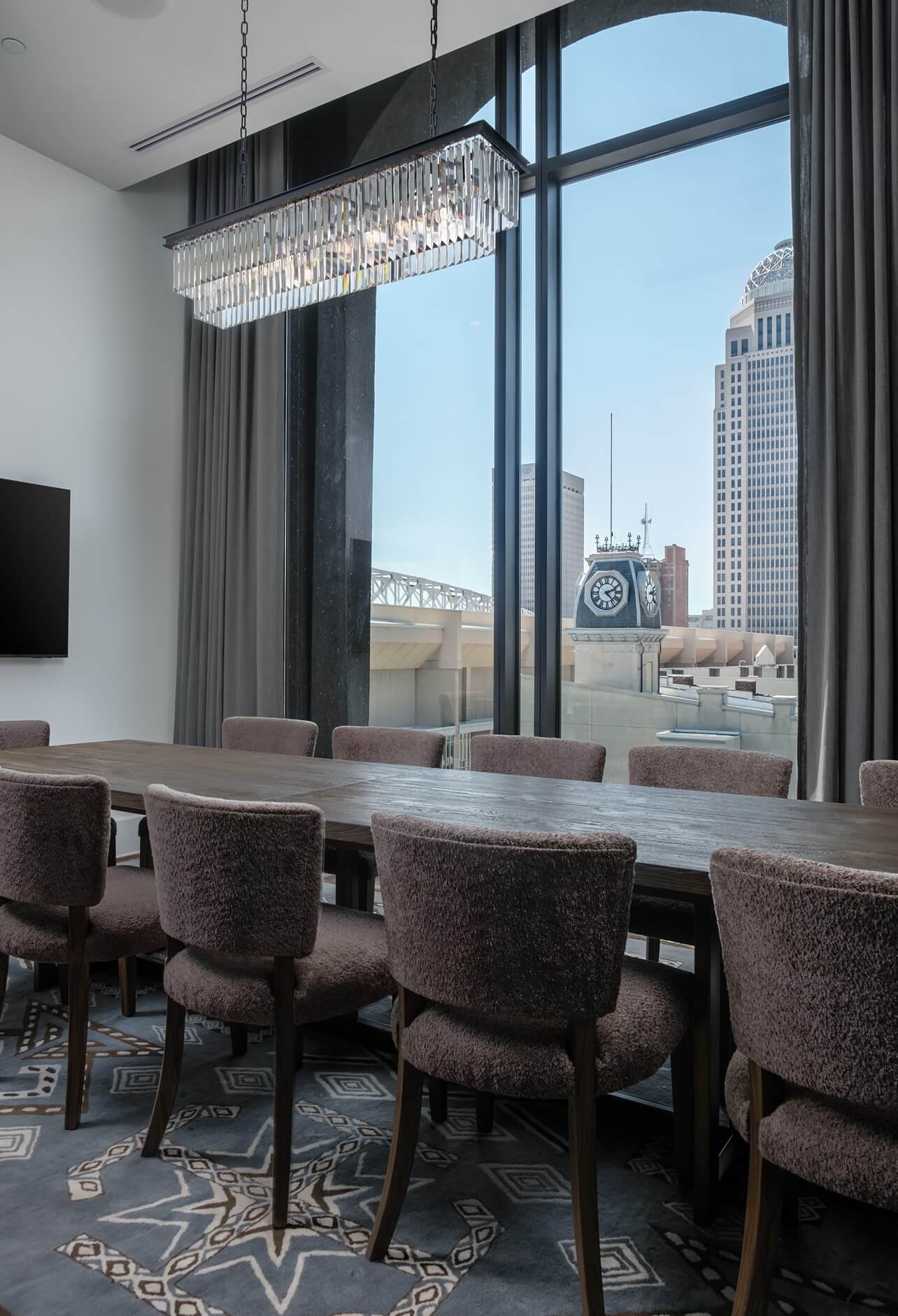 A conference room with a large table and chairs.