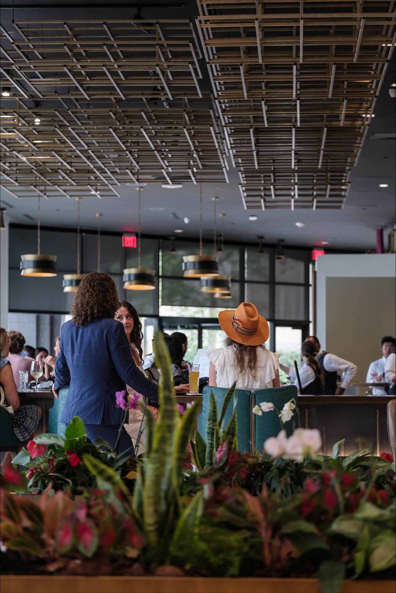 A group of people sitting at a table in a restaurant.