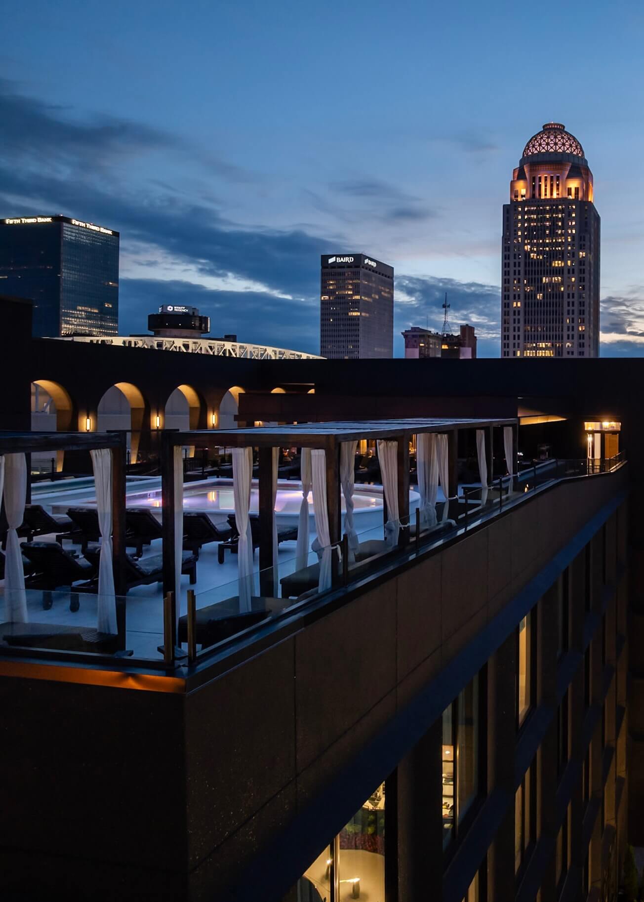 A view of a city at night from a rooftop.