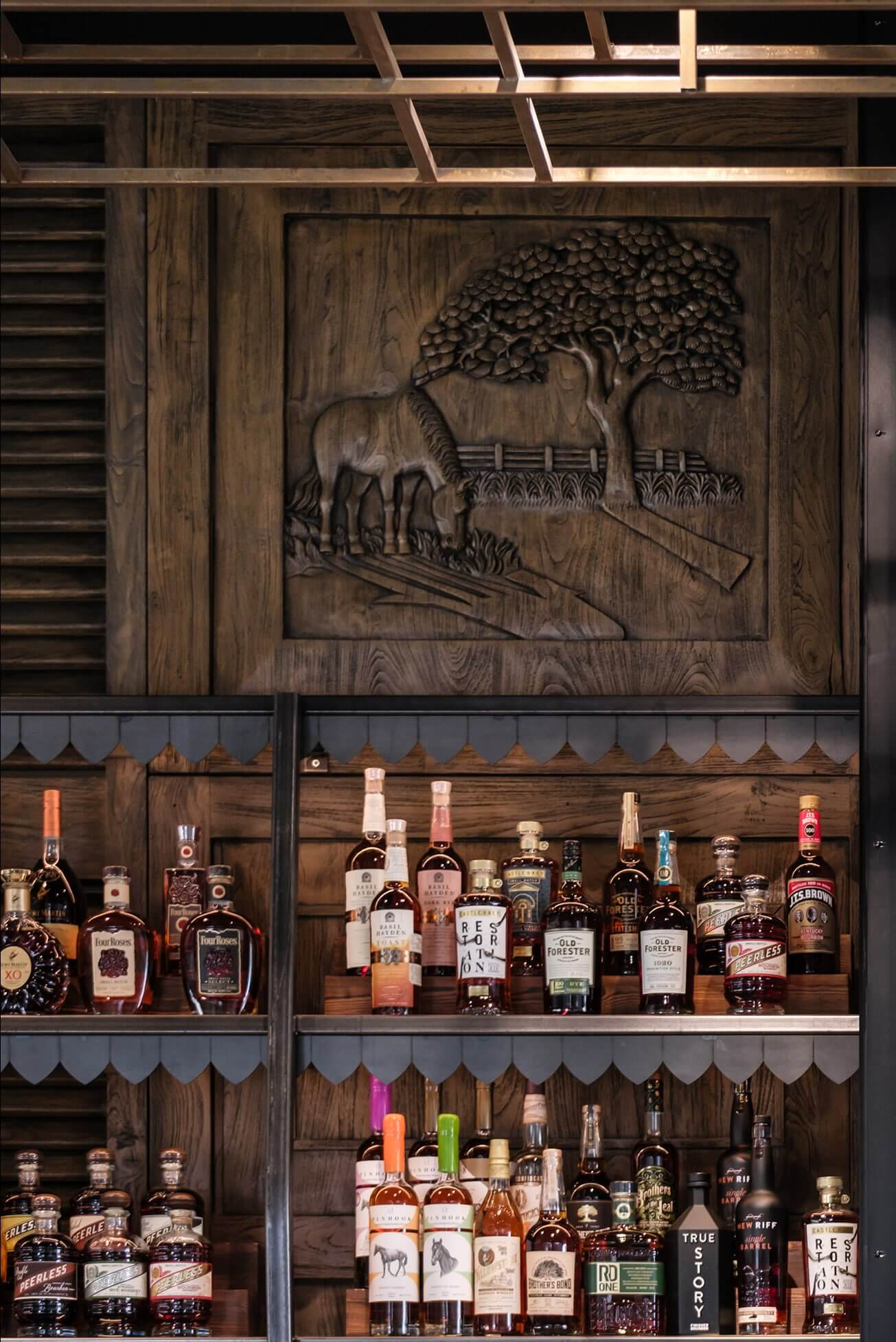 A wooden shelf filled with bottles of liquor.