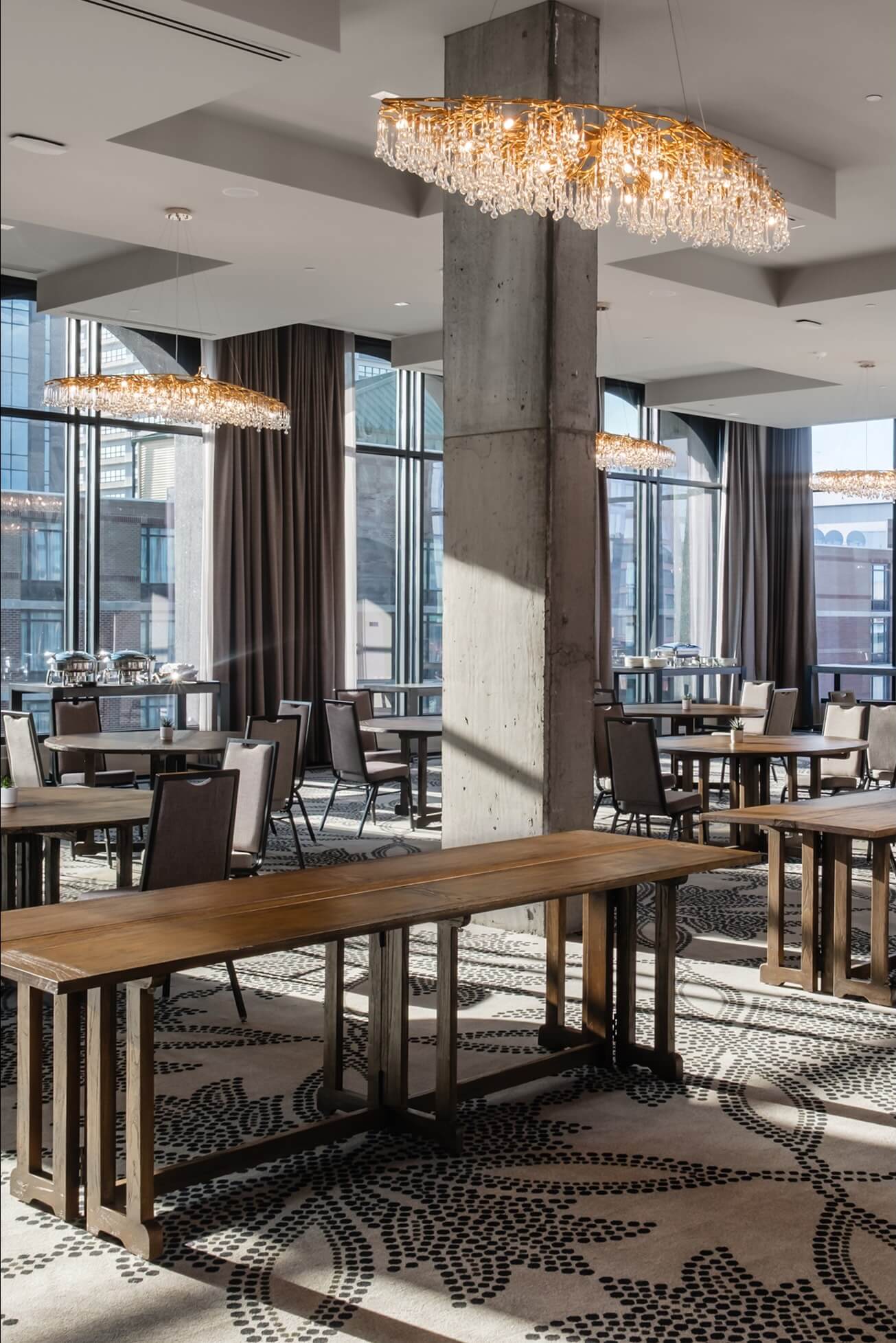 A dining room with a long wooden table and chairs.