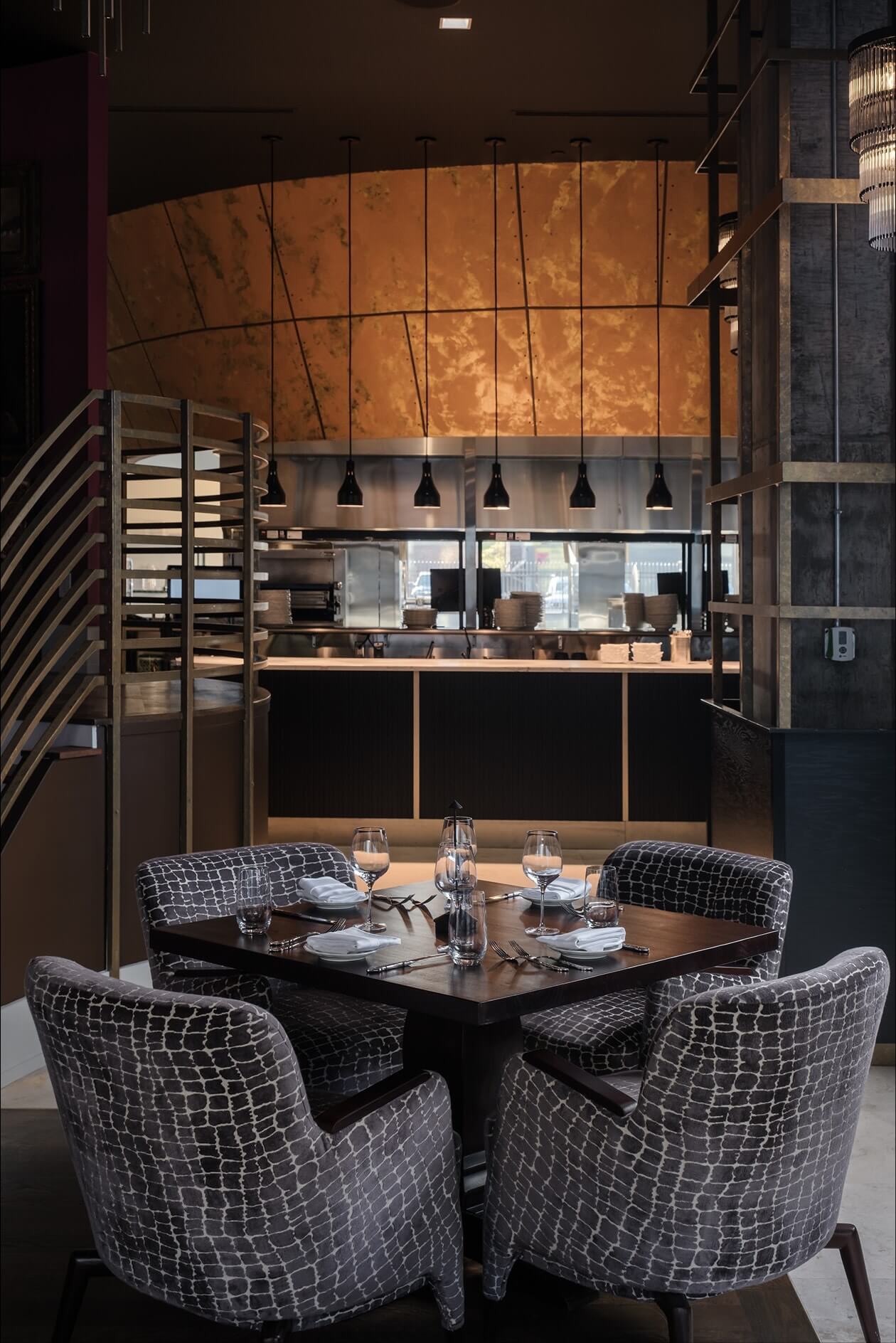 A dining room with a table and chairs.