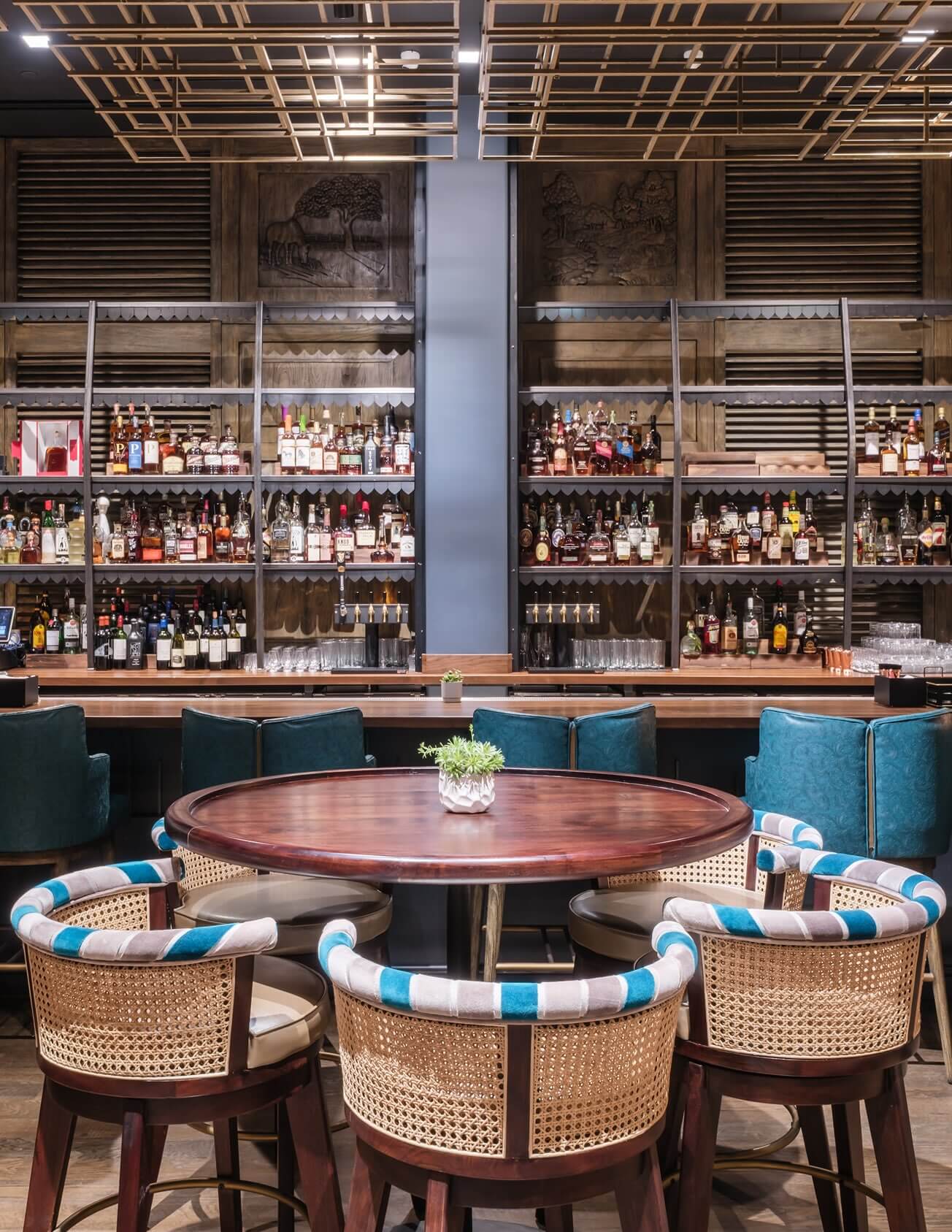 A table with four chairs around it in a bar.