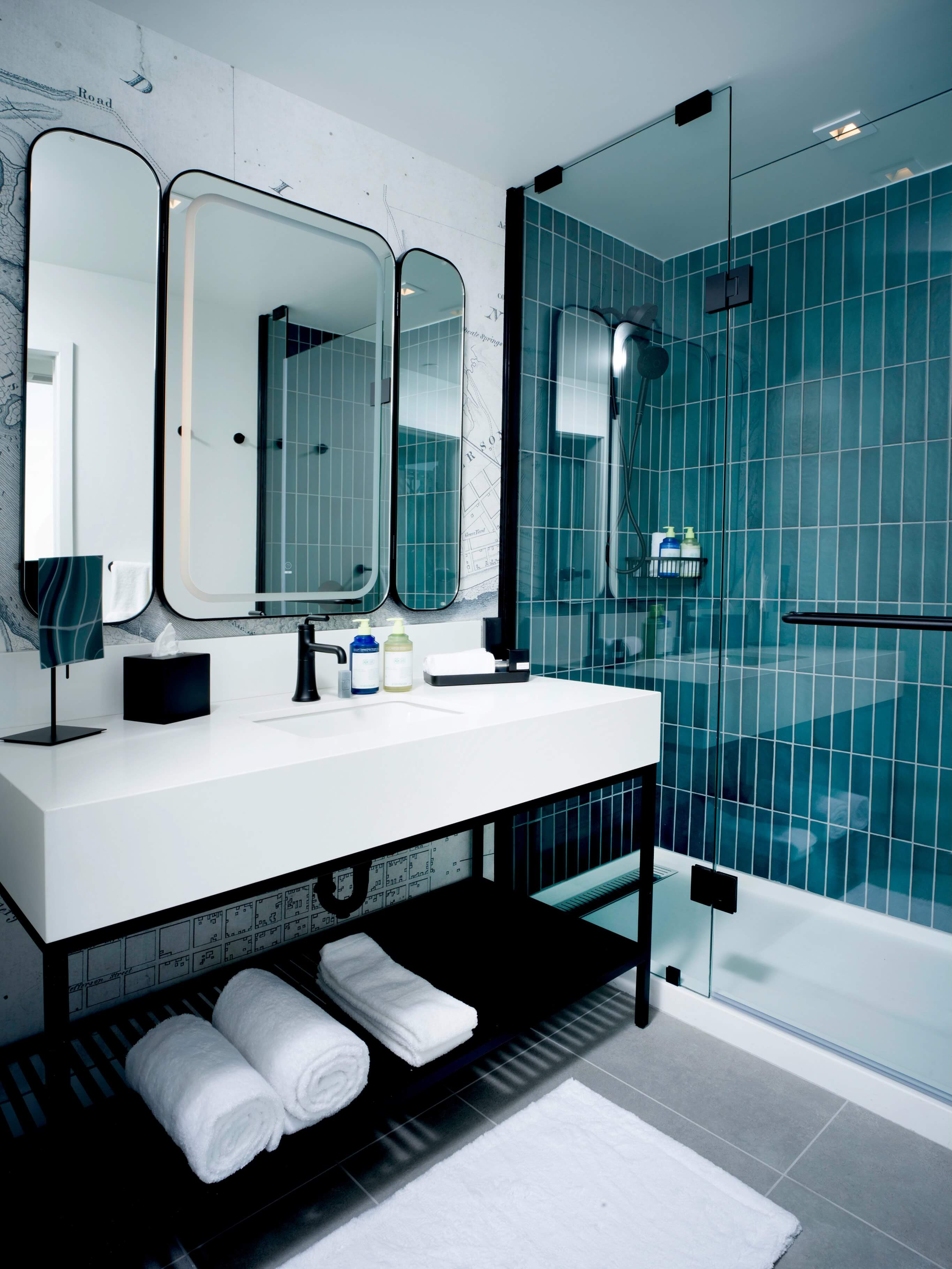 A bathroom with a sink, mirror, and bathtub.