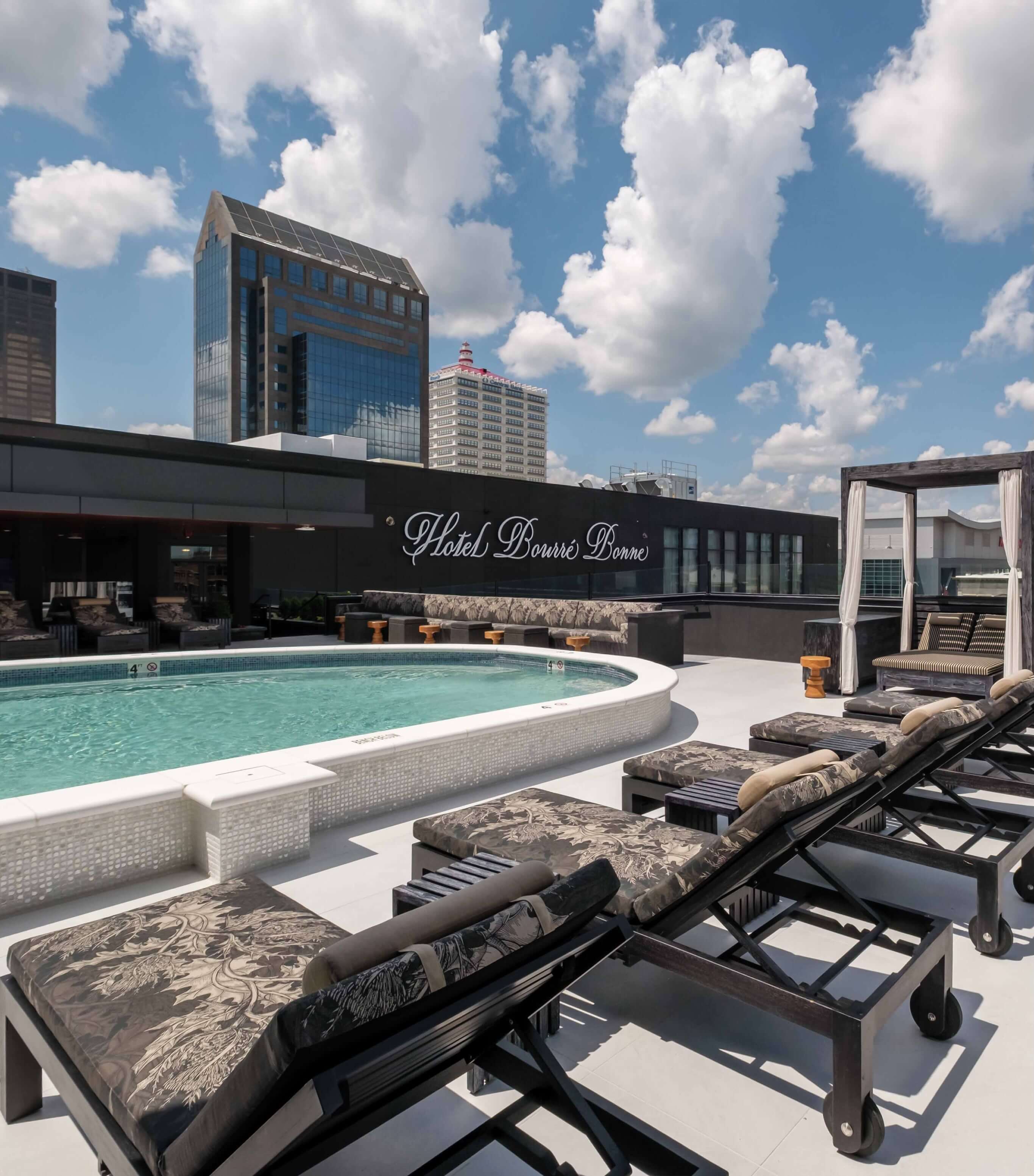 A couple of lounge chairs sitting next to a swimming pool.