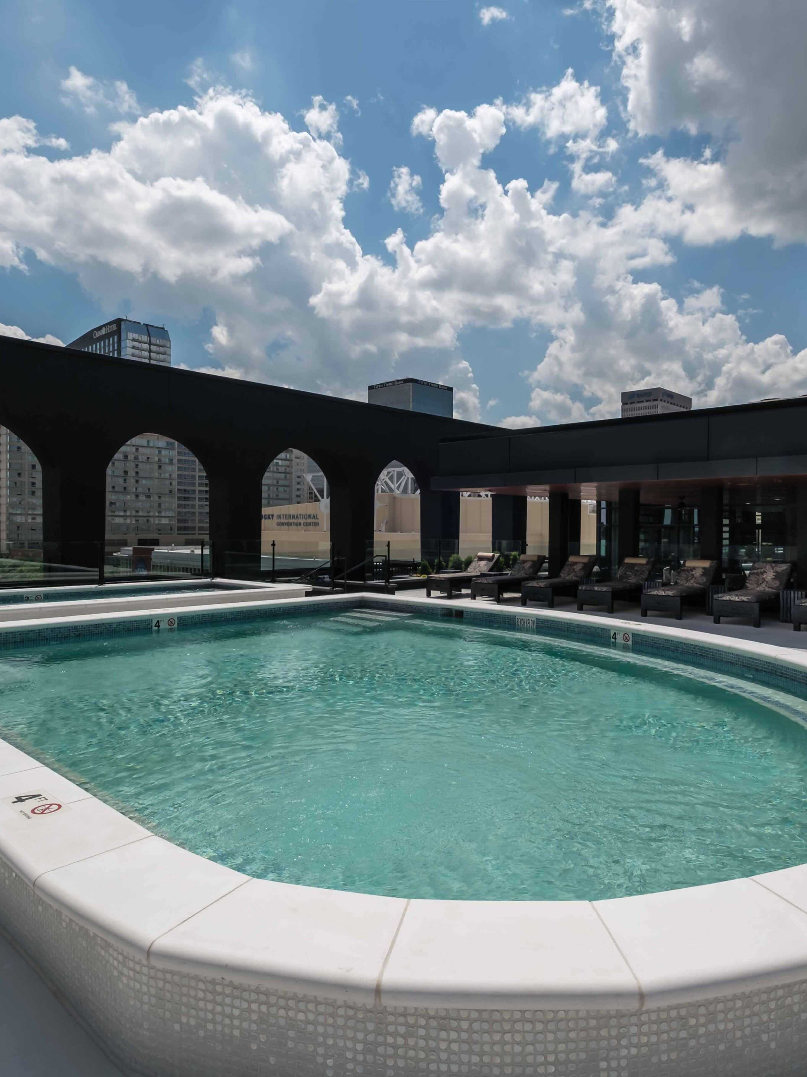 A large swimming pool surrounded by lounge chairs.