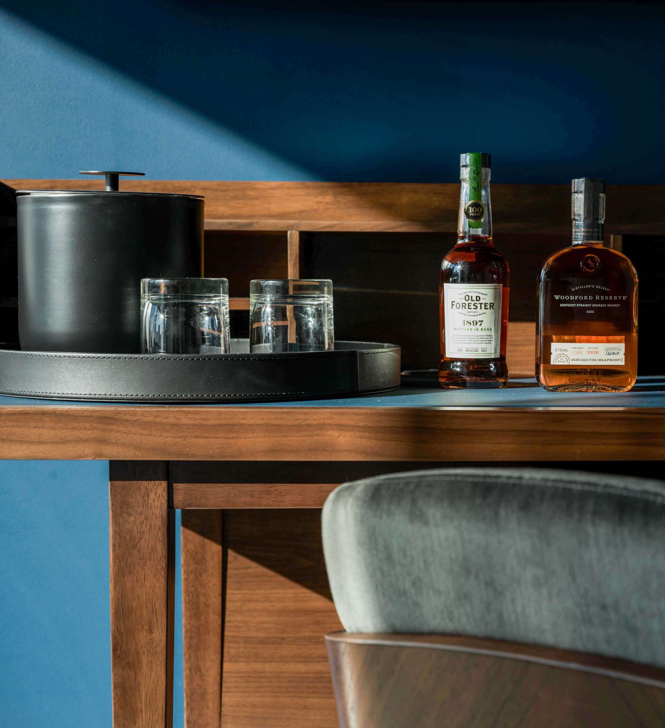 A bottle of whiskey sitting on top of a wooden table.