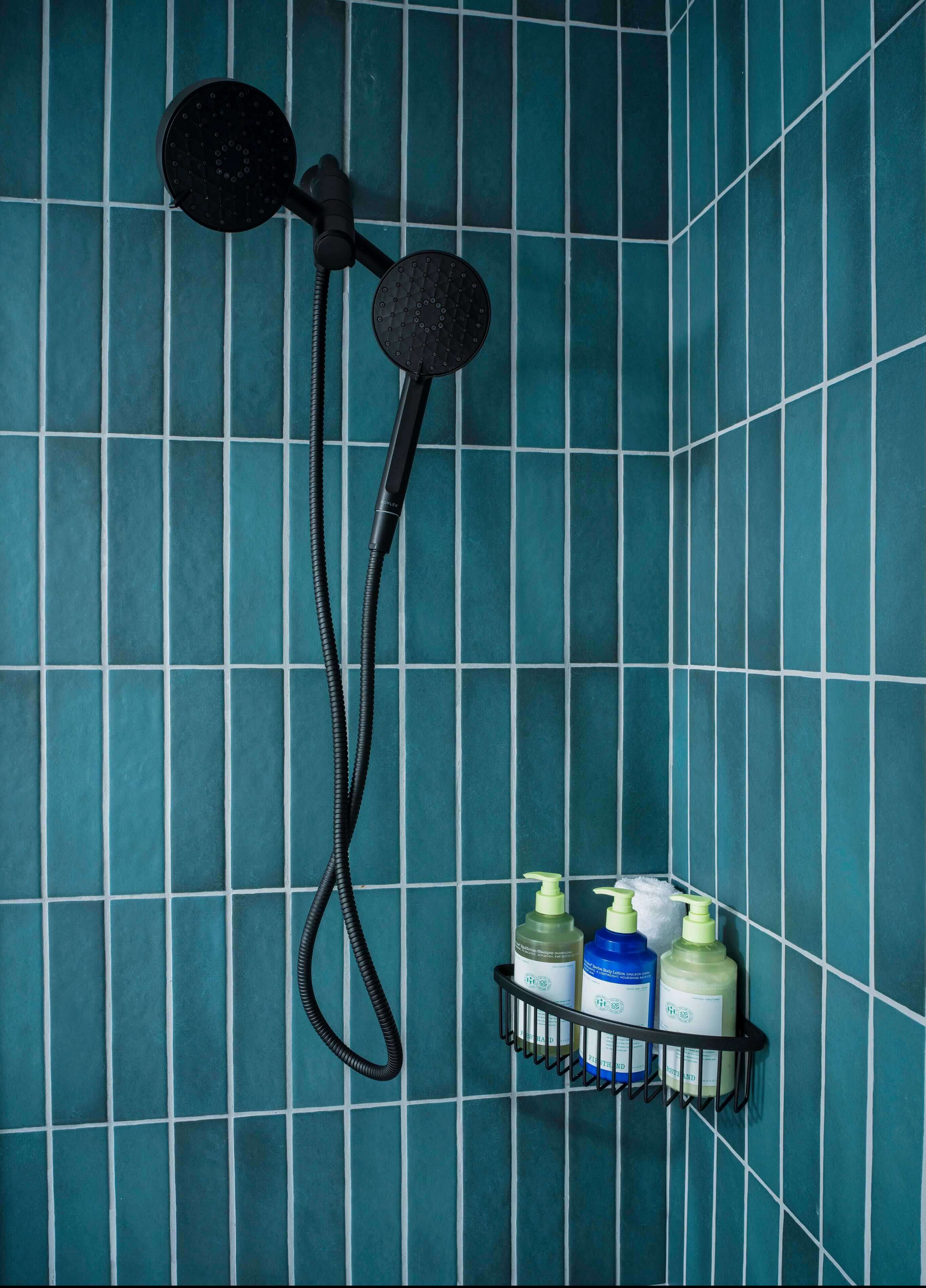 A shower head with soap and lotion in it.