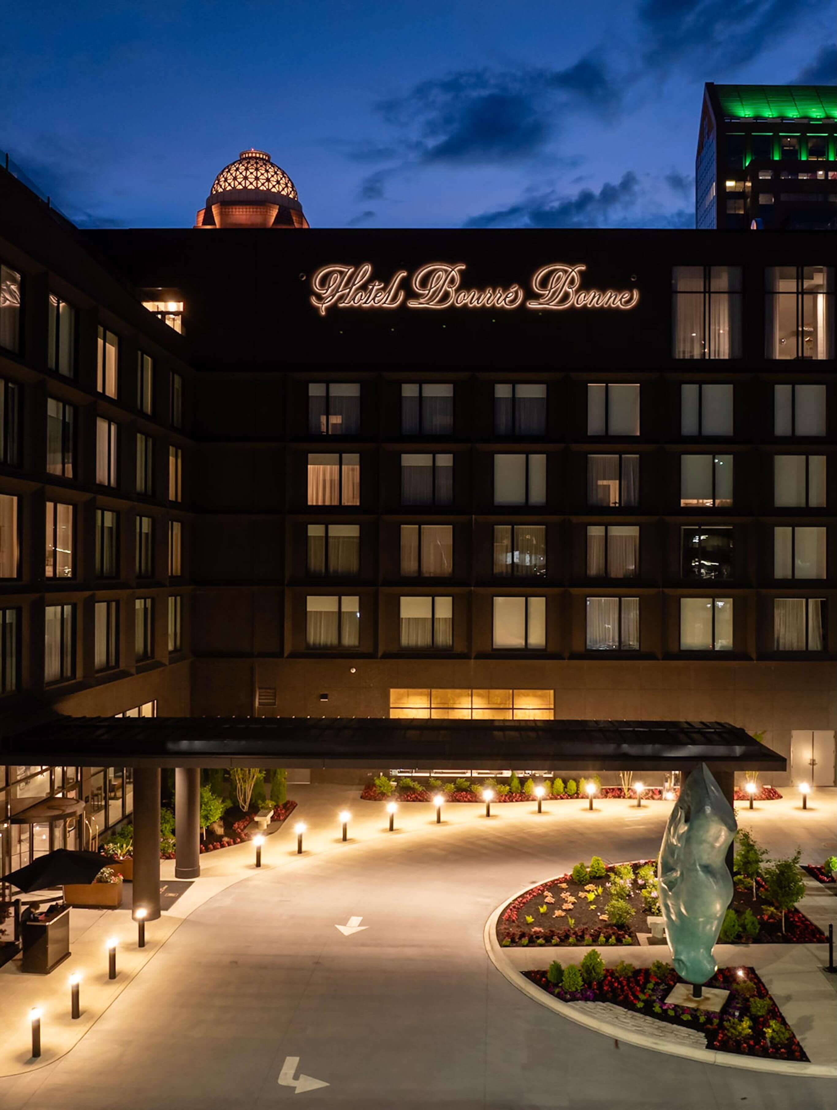 A large hotel building with a lit up entrance.