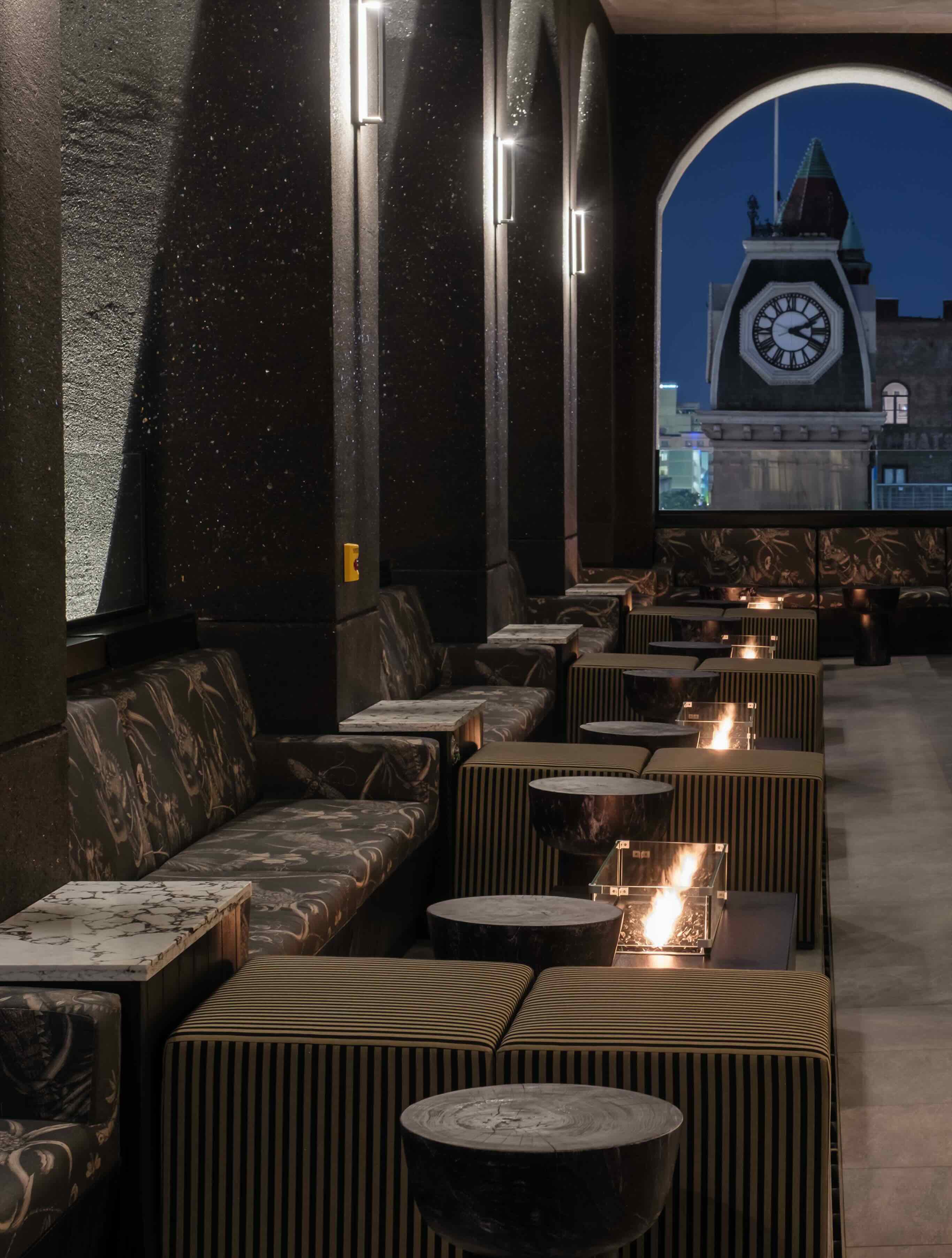 A restaurant with a clock tower in the background.