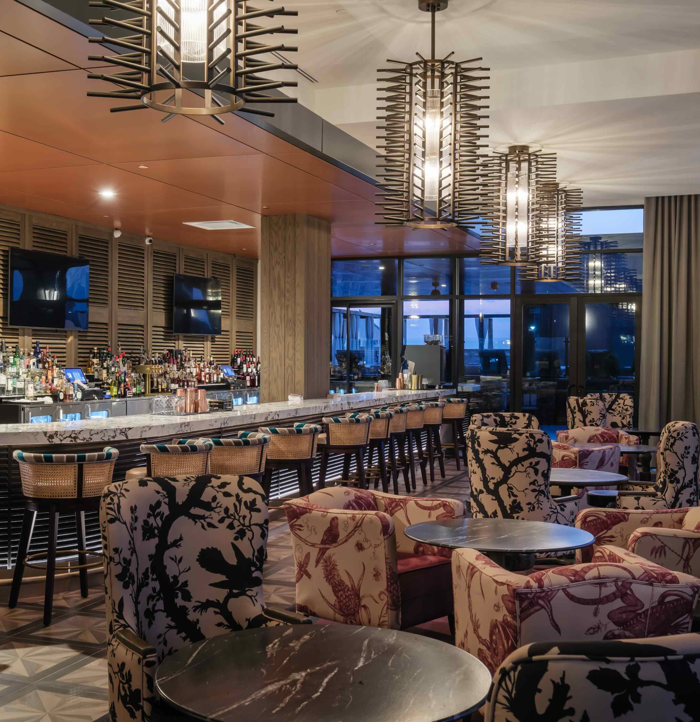 A bar with a bunch of chairs around it.