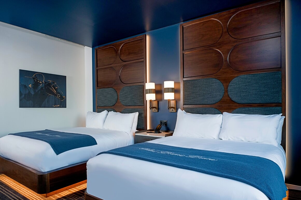 A couple of beds sitting next to each other in a room.