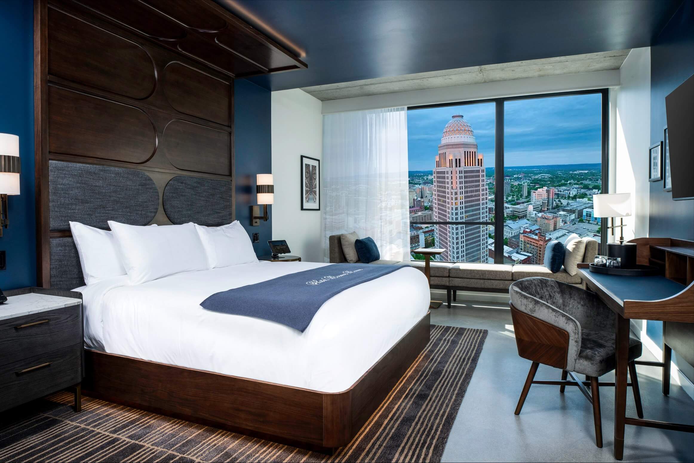 A hotel room with a view of the city.