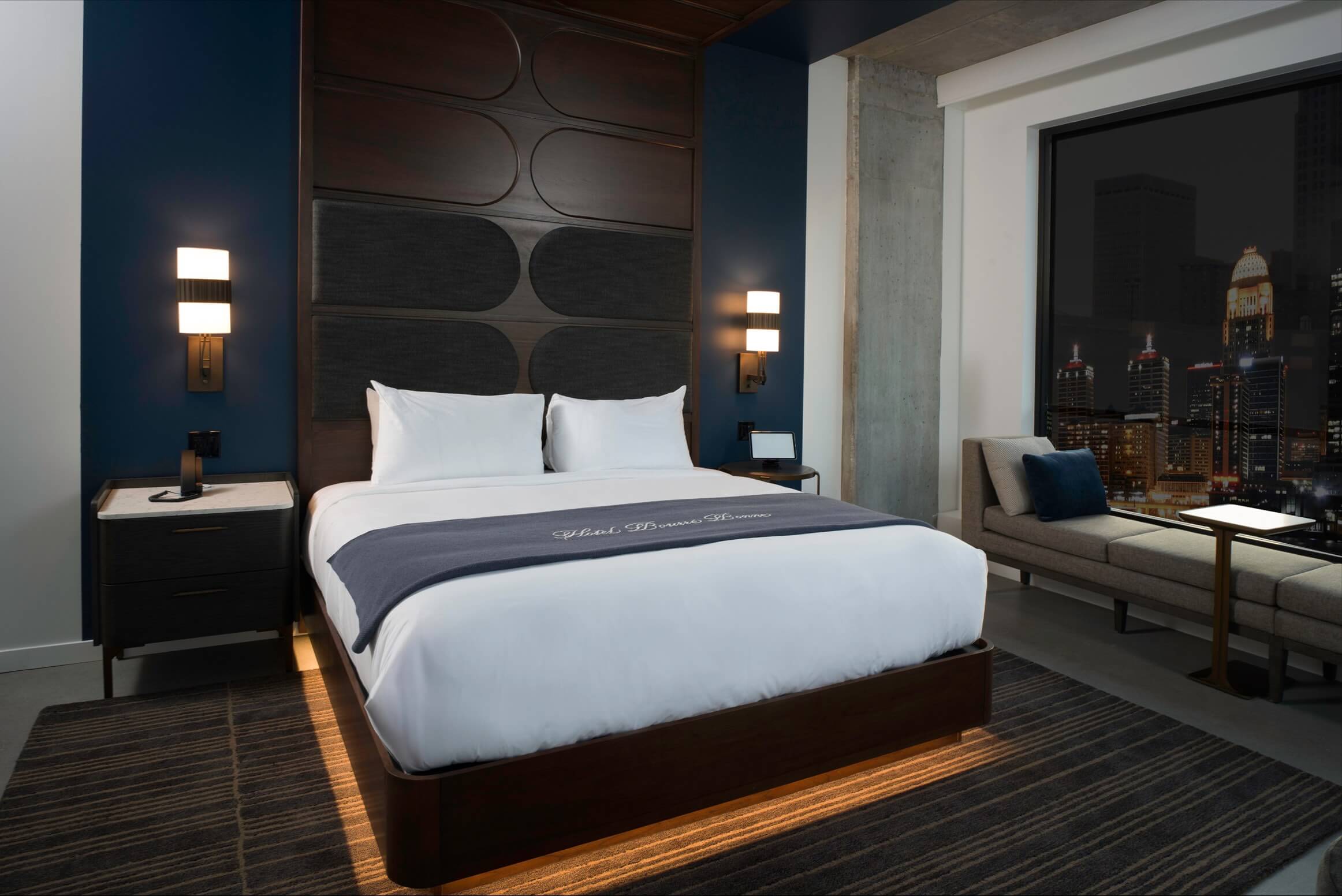 A large bed sitting in a bedroom next to a window.