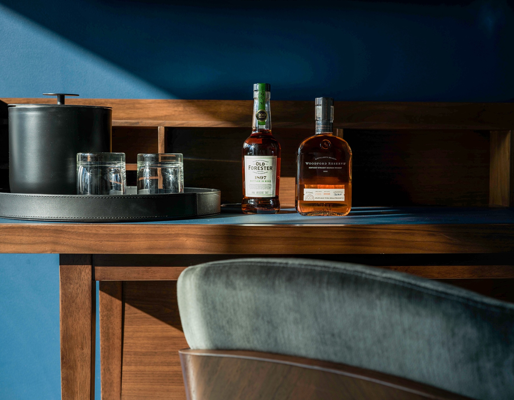 A bottle of whiskey sitting on top of a wooden table.