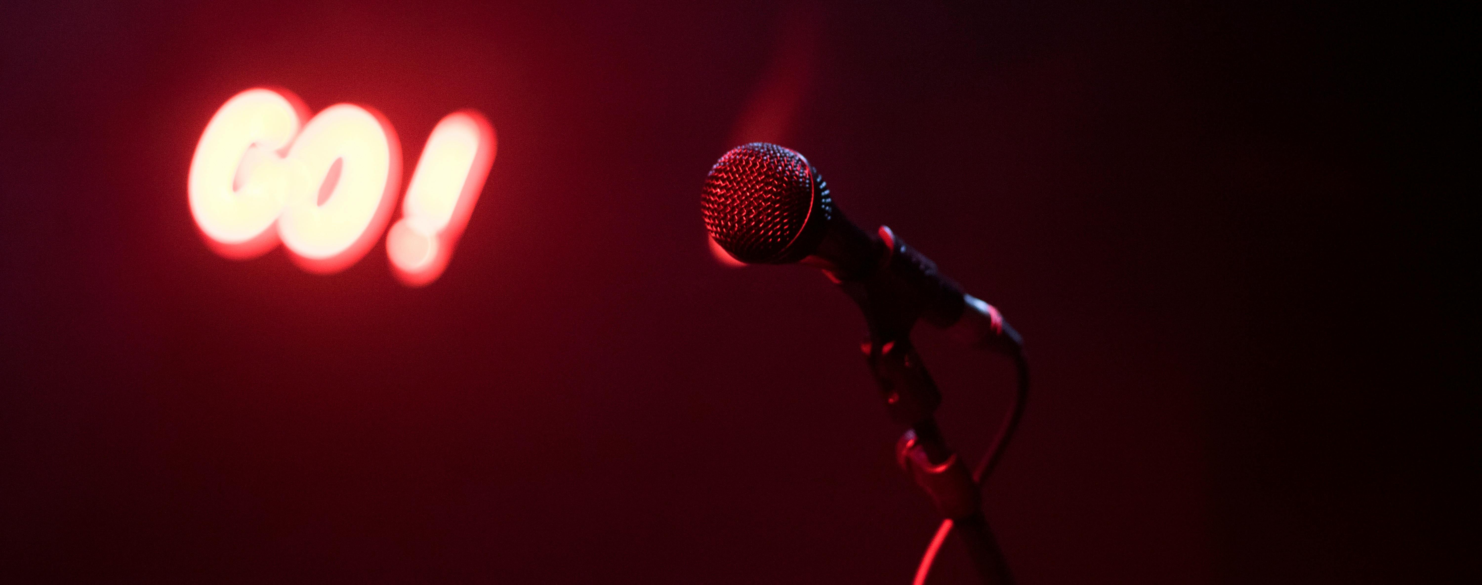 A microphone in front of a red light.