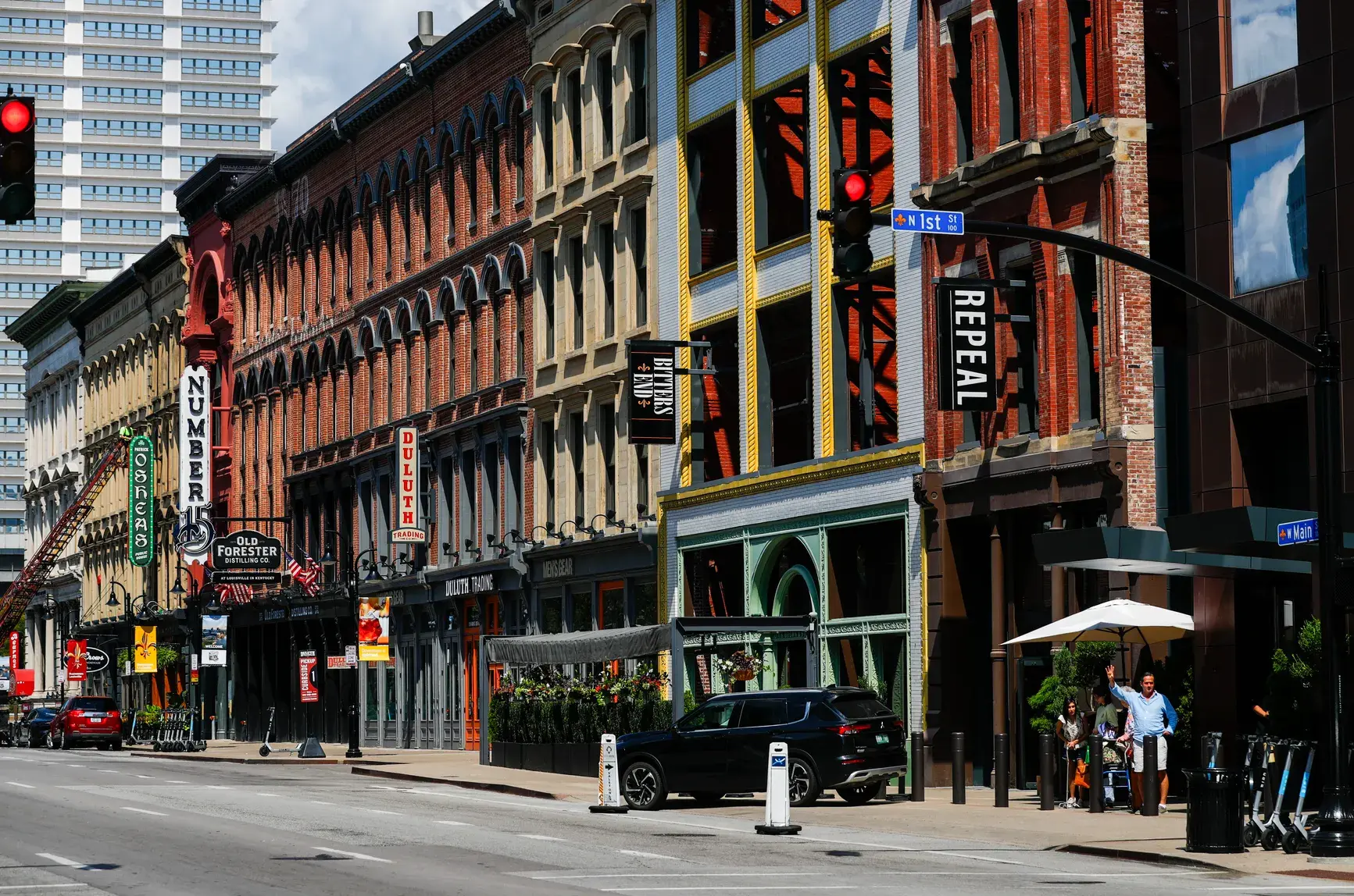 A city street filled with lots of tall buildings.